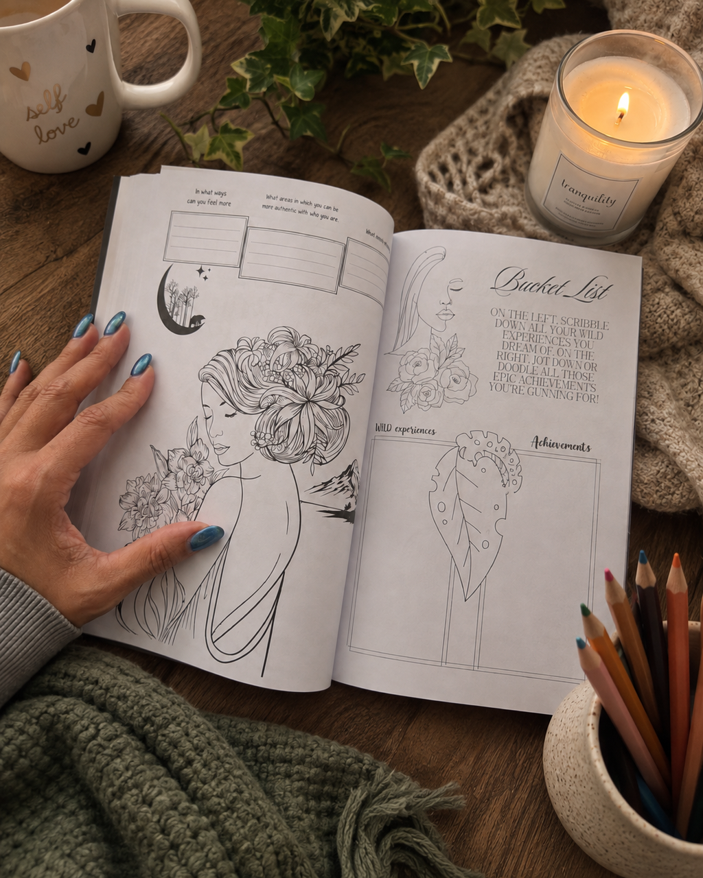 Metamorphosis Embrace The Beauty Within workbook, styled on a wooden surface with a hand holding one page, a lit candle, a mug, greenery, and colored pencils nearby.