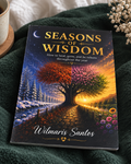 The book 'Seasons of Wisdom' by Wilmaris Santos is displayed on a dark green textured blanket next to a coffee cup and dried flowers. The cover features a beautiful illustration of a tree with autumn and spring foliage, with the title in gold lettering.